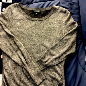 Woman’s silver and black sweater